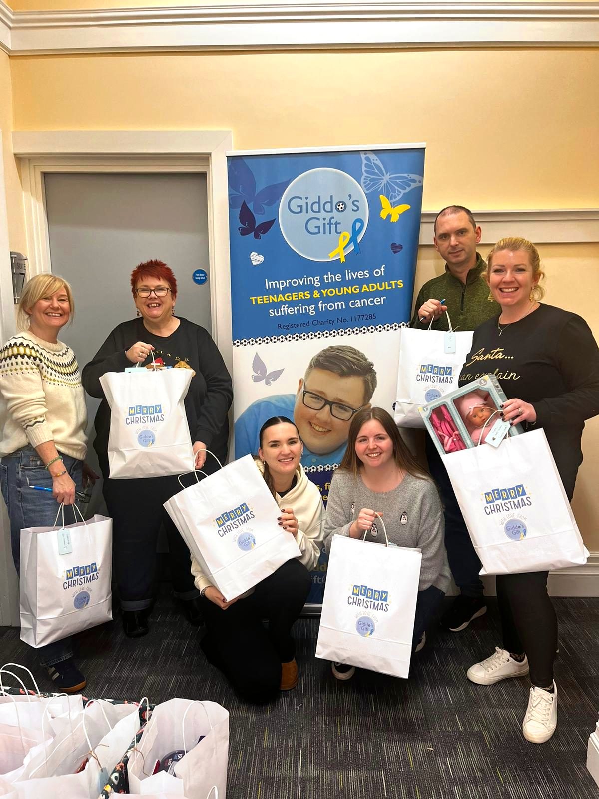 Team Giddo with bags of Christmas gifts for hospital wards