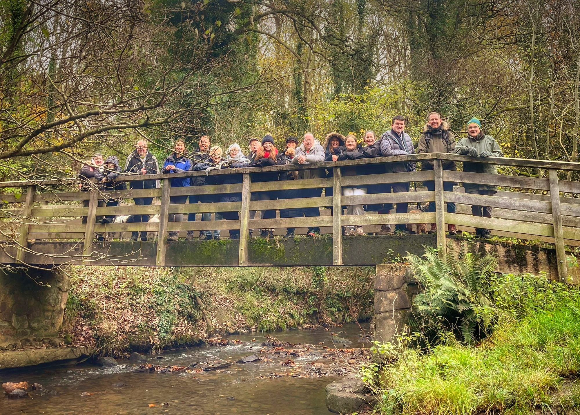 Team Giddo and supporters on a wooden footbridge on a family walk
