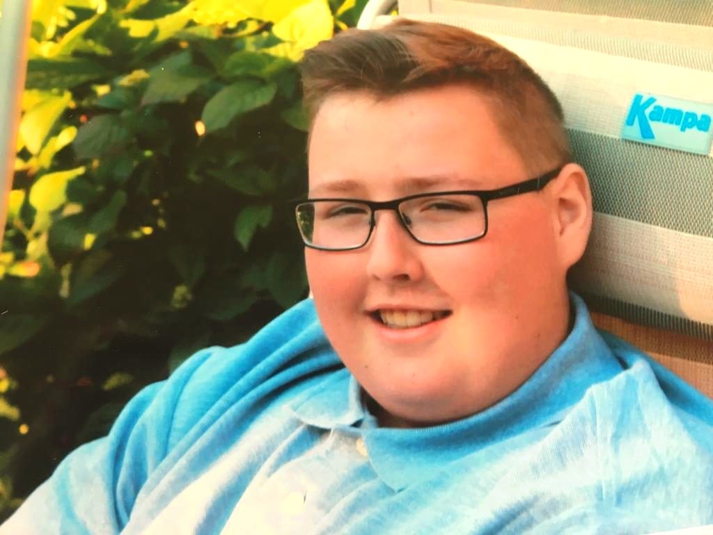 Jordan smiling in a pale blue shirt